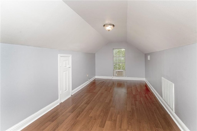 additional living space featuring wood-type flooring and lofted ceiling