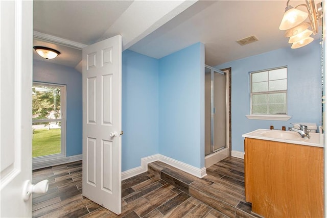 bathroom with a shower with door, vanity, and hardwood / wood-style flooring