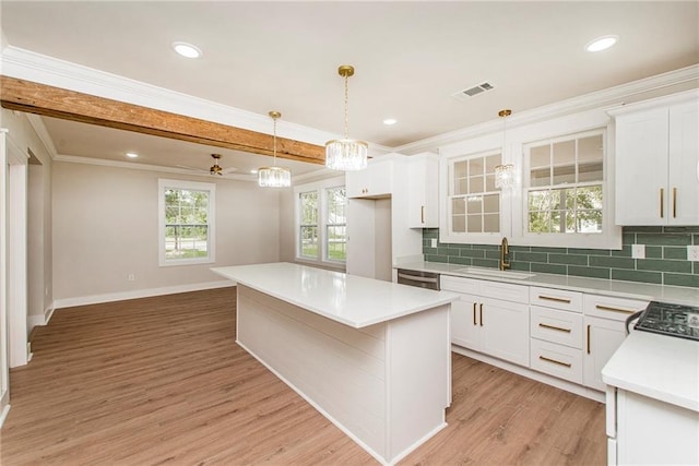 kitchen featuring white cabinets, light hardwood / wood-style flooring, sink, and a kitchen island