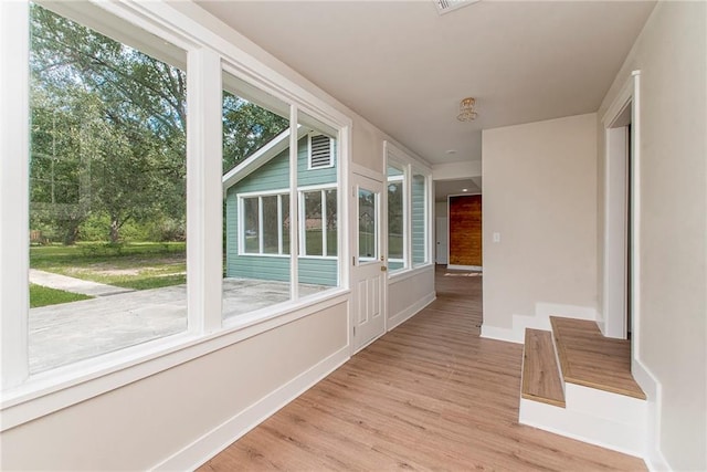 unfurnished sunroom featuring a healthy amount of sunlight