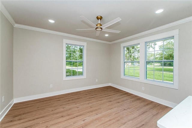 unfurnished room featuring light hardwood / wood-style flooring, ornamental molding, ceiling fan, and a wealth of natural light