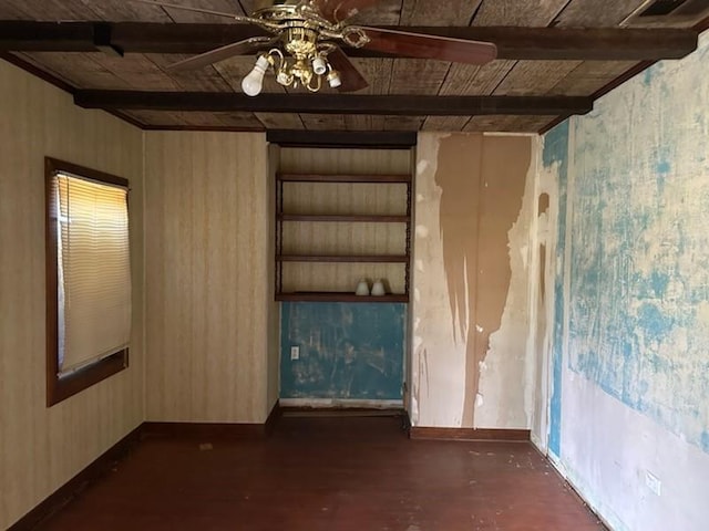 spare room with beamed ceiling, baseboards, built in shelves, a ceiling fan, and wood ceiling