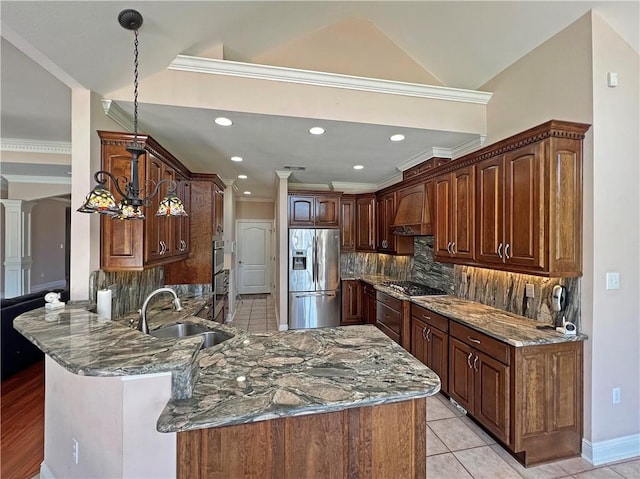 kitchen with kitchen peninsula, backsplash, dark stone counters, sink, and appliances with stainless steel finishes