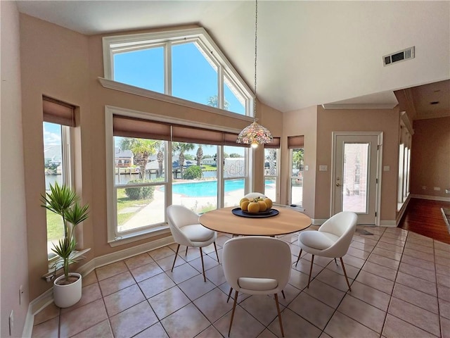 sunroom featuring vaulted ceiling and plenty of natural light