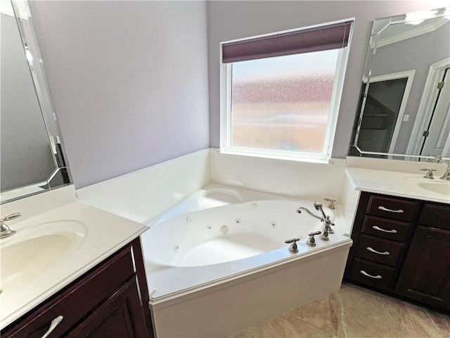 bathroom with vanity, crown molding, a bathtub, and tile patterned flooring