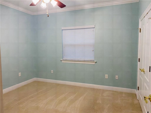 carpeted empty room with ceiling fan and ornamental molding