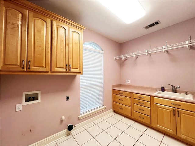 washroom featuring hookup for a washing machine, sink, hookup for an electric dryer, hookup for a gas dryer, and cabinets