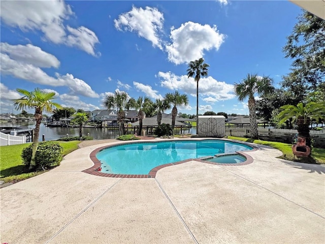 view of swimming pool with a patio area and a water view