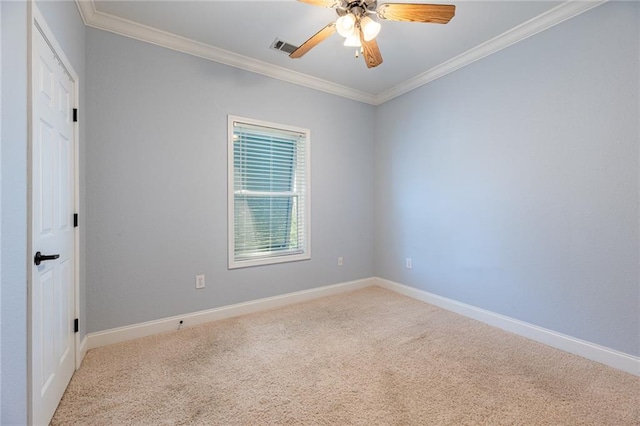 carpeted empty room featuring crown molding and ceiling fan