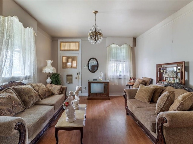 living room with dark hardwood / wood-style floors and a notable chandelier