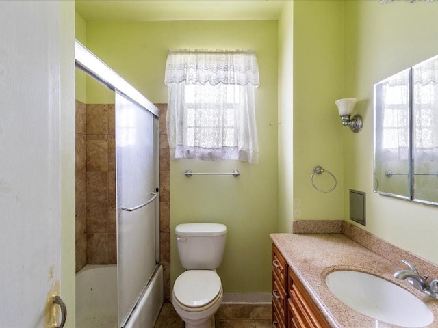 full bathroom featuring vanity, tile patterned flooring, toilet, and combined bath / shower with glass door