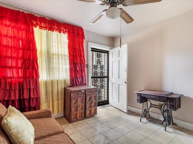 sitting room featuring light tile patterned floors and ceiling fan