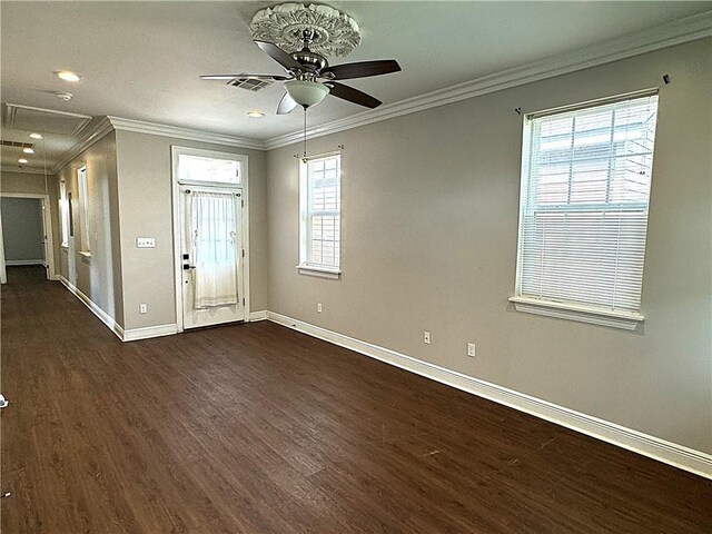 spare room featuring crown molding, dark hardwood / wood-style flooring, and ceiling fan