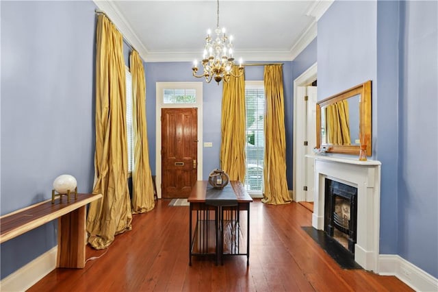 interior space featuring an inviting chandelier, a fireplace, crown molding, and dark wood-type flooring