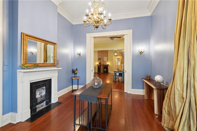 interior space featuring a notable chandelier, crown molding, and dark wood-type flooring