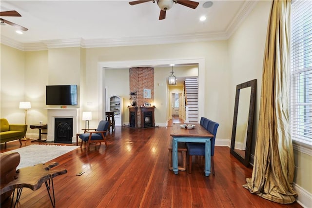 interior space featuring ceiling fan, ornamental molding, and dark hardwood / wood-style flooring