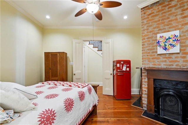 bedroom with crown molding, ceiling fan, and hardwood / wood-style flooring