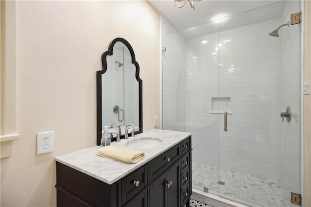 bathroom featuring vanity and a shower with door