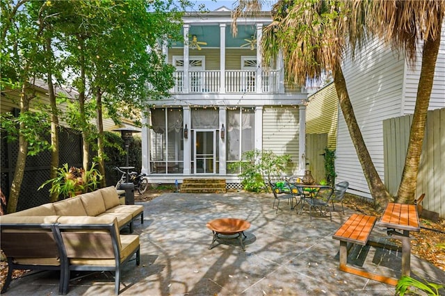 back of house featuring a patio, a balcony, an outdoor living space, and ceiling fan