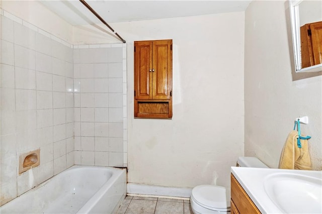 full bathroom featuring tiled shower / bath combo, vanity, tile patterned flooring, and toilet