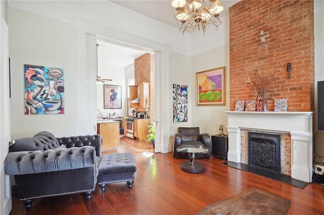 living room featuring hardwood / wood-style flooring and ceiling fan with notable chandelier