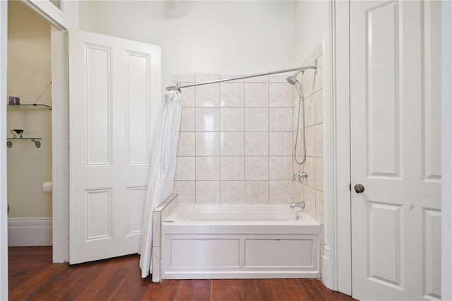 bathroom with hardwood / wood-style floors and shower / bath combination with curtain