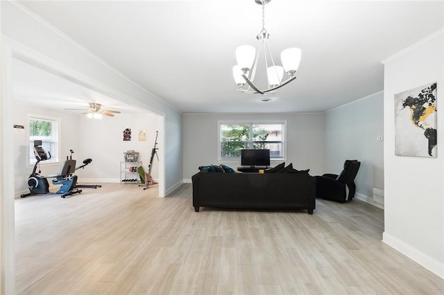 living room featuring light wood-type flooring, ceiling fan with notable chandelier, and ornamental molding