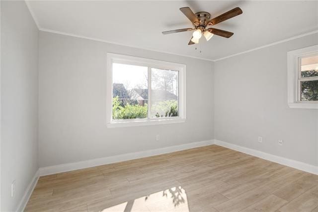 spare room featuring ceiling fan, light hardwood / wood-style flooring, ornamental molding, and a wealth of natural light