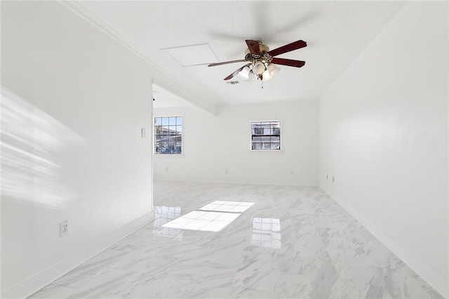 empty room featuring crown molding and ceiling fan