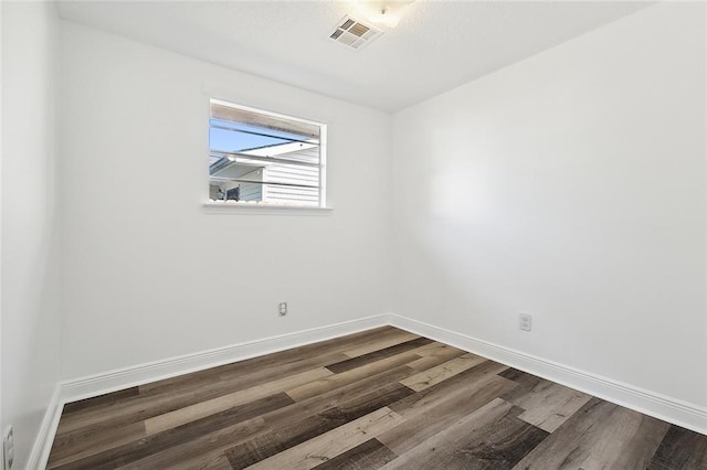 unfurnished room with wood-type flooring