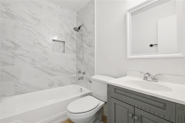 full bathroom with tiled shower / bath combo, vanity, and toilet