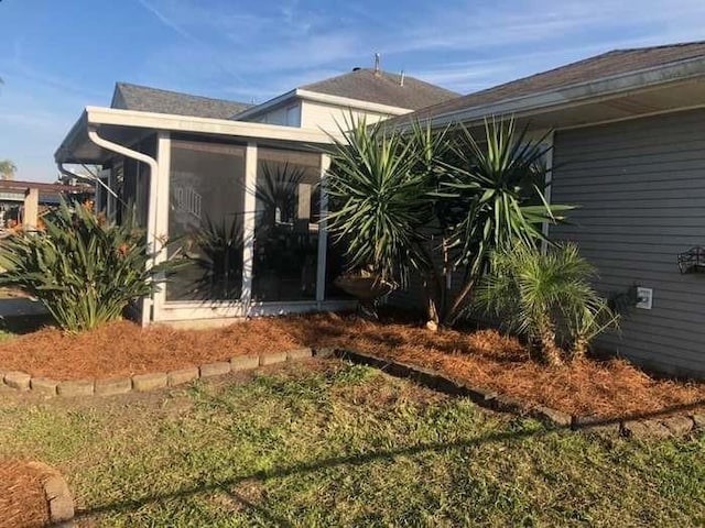 view of side of home featuring a sunroom