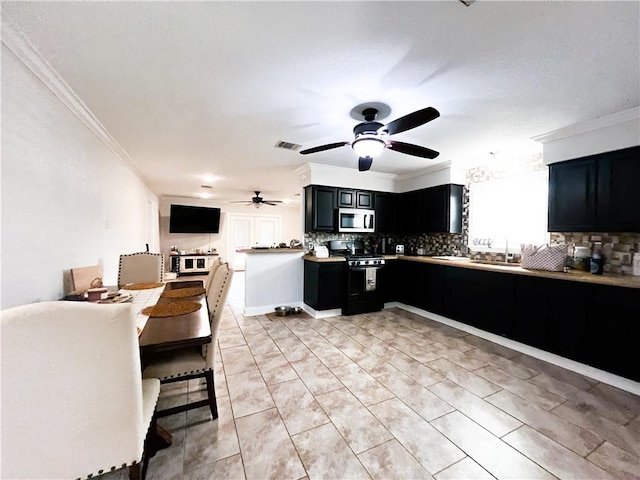 kitchen featuring ceiling fan, sink, ornamental molding, black range, and backsplash