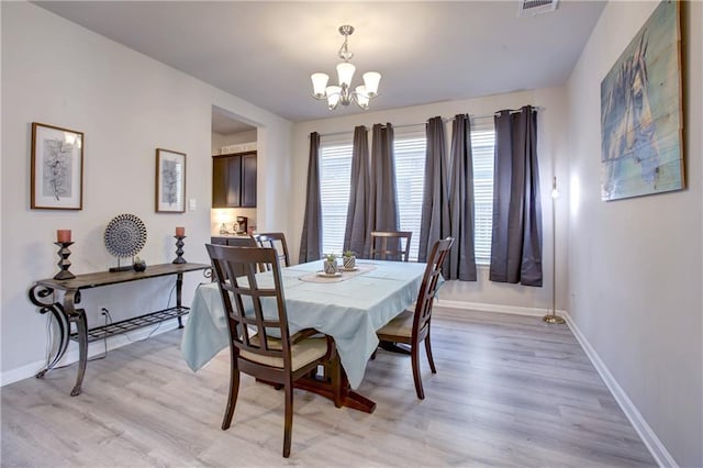 5572 Wake Reserve Rd, Slidell, LA 70461 - dining space featuring baseboards, a chandelier, and light wood-type flooring
