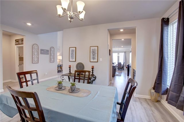 5572 Wake Reserve Rd, Slidell, LA 70461 - dining area featuring light wood-style flooring, a chandelier, baseboards, and recessed lighting