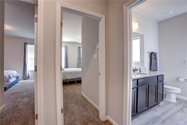 5572 Wake Reserve Rd, Slidell, LA 70461 - hall with a sink, baseboards, and light carpet