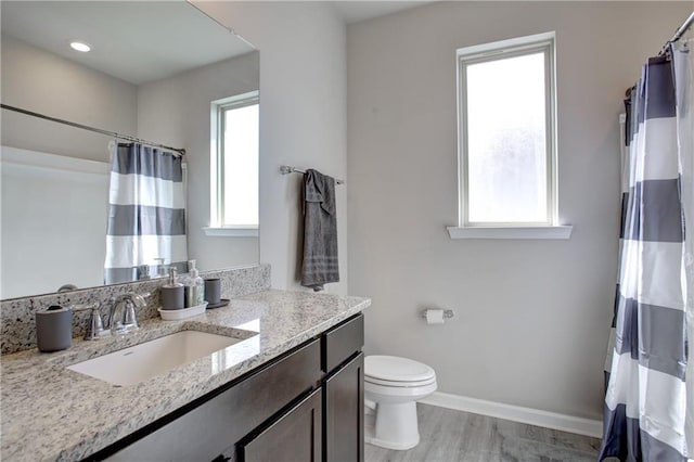 5572 Wake Reserve Rd, Slidell, LA 70461 - bathroom featuring toilet, baseboards, vanity, wood finished floors, and curtained shower