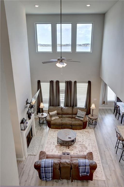 5572 Wake Reserve Rd, Slidell, LA 70461 - living area with plenty of natural light, wood finished floors, a towering ceiling, and recessed lighting