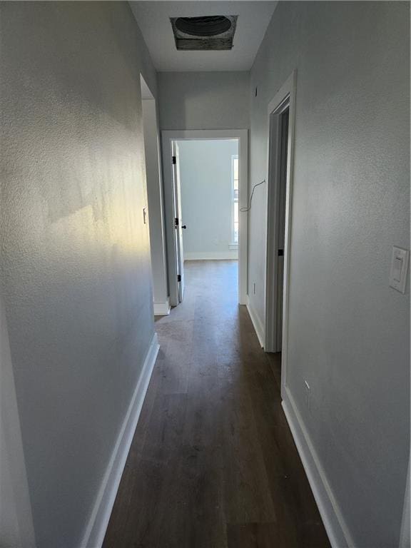 hallway with dark hardwood / wood-style flooring