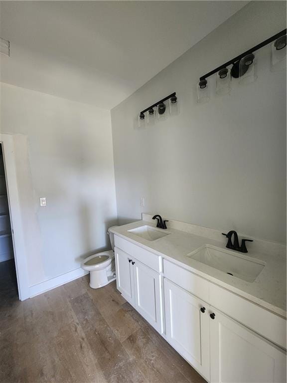 bathroom featuring hardwood / wood-style floors, vanity, and toilet