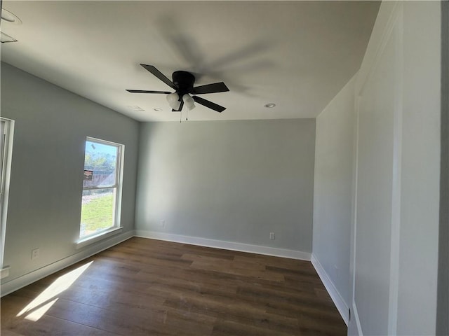 spare room featuring ceiling fan and dark wood-type flooring