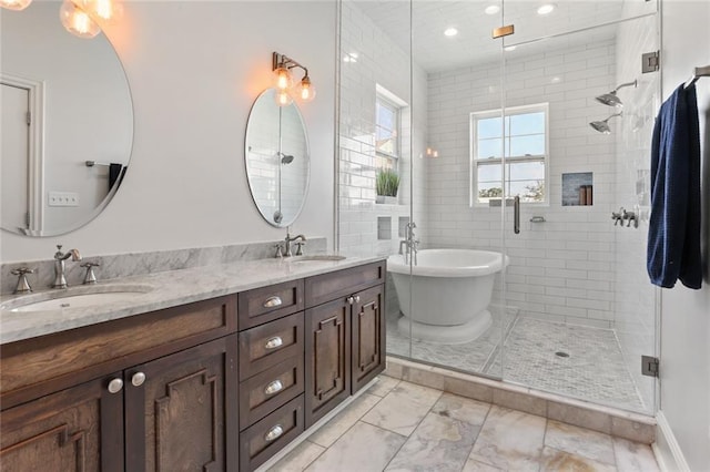 bathroom with vanity and separate shower and tub