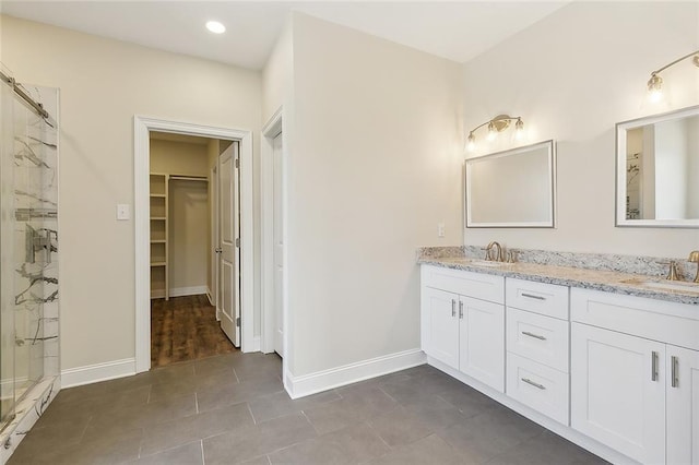 bathroom featuring vanity, a shower with door, and tile patterned floors