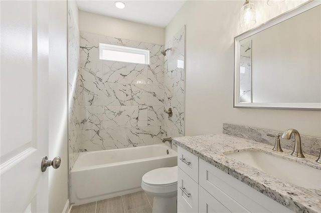 full bathroom with vanity, toilet, and tiled shower / bath