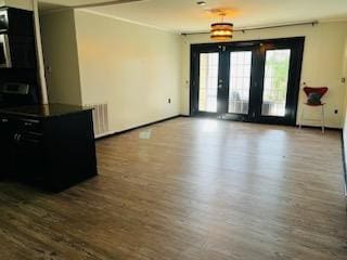 spare room featuring dark hardwood / wood-style flooring and radiator