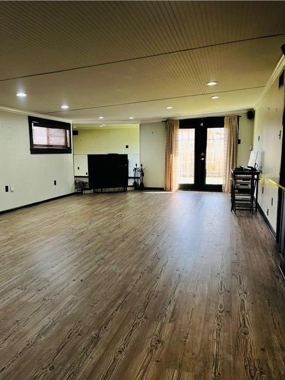 interior space featuring french doors, ornamental molding, and dark hardwood / wood-style floors