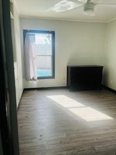 unfurnished room featuring hardwood / wood-style flooring and ornamental molding