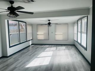 interior space with hardwood / wood-style flooring and ceiling fan