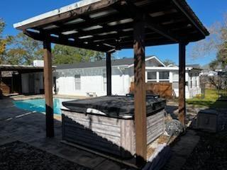 view of patio / terrace with a hot tub