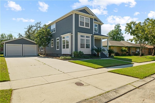 view of front of house featuring an outbuilding, a front yard, and a garage